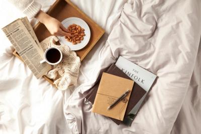 almonds in a bowl next to reading materials