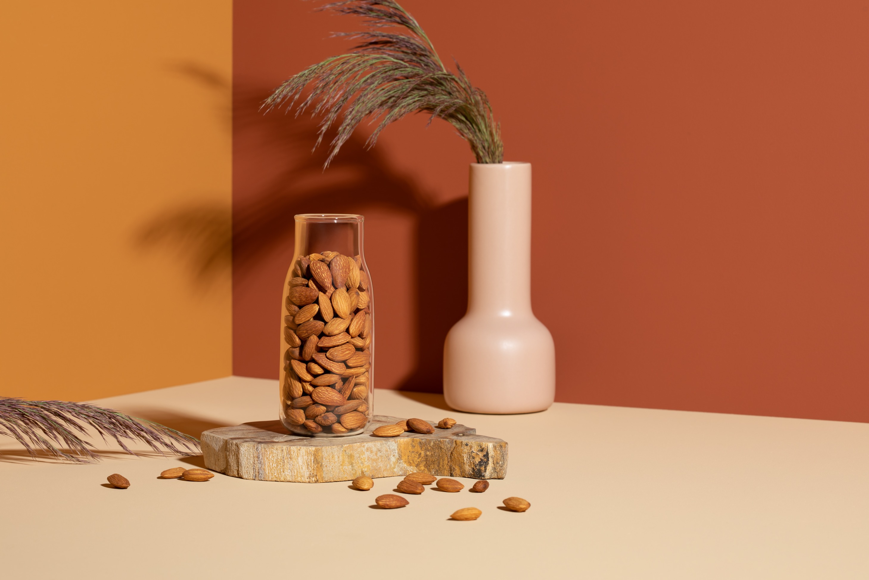 almond in a glass bottle with a brownish background behind