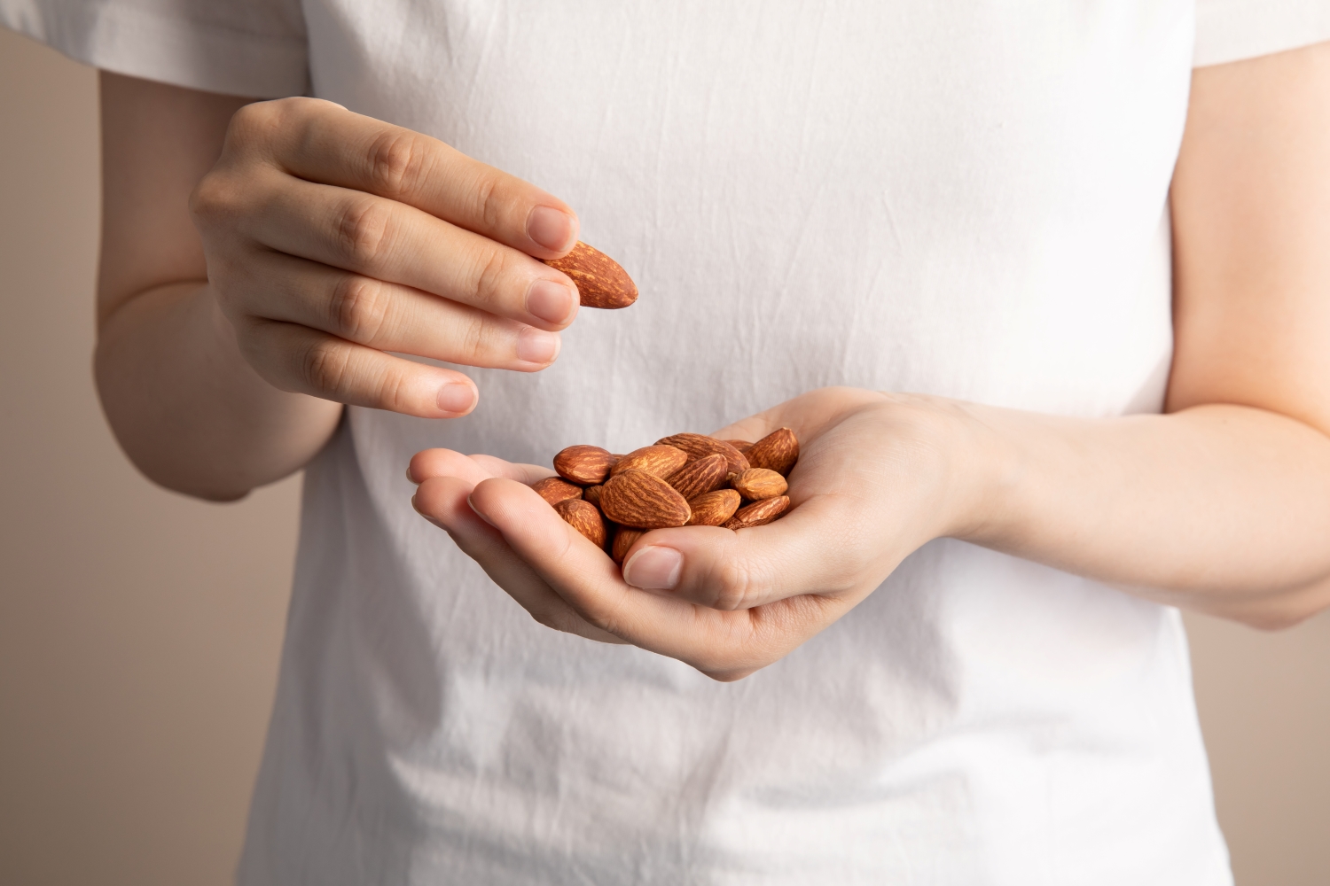 holding almonds with hands