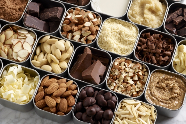 Variety of almonds and chocolate in containers