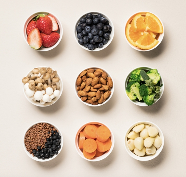 Bowls of almonds, fruits, and vegetables