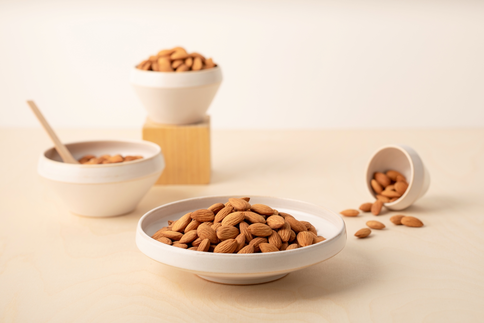 almonds displayed on plates and bowls
